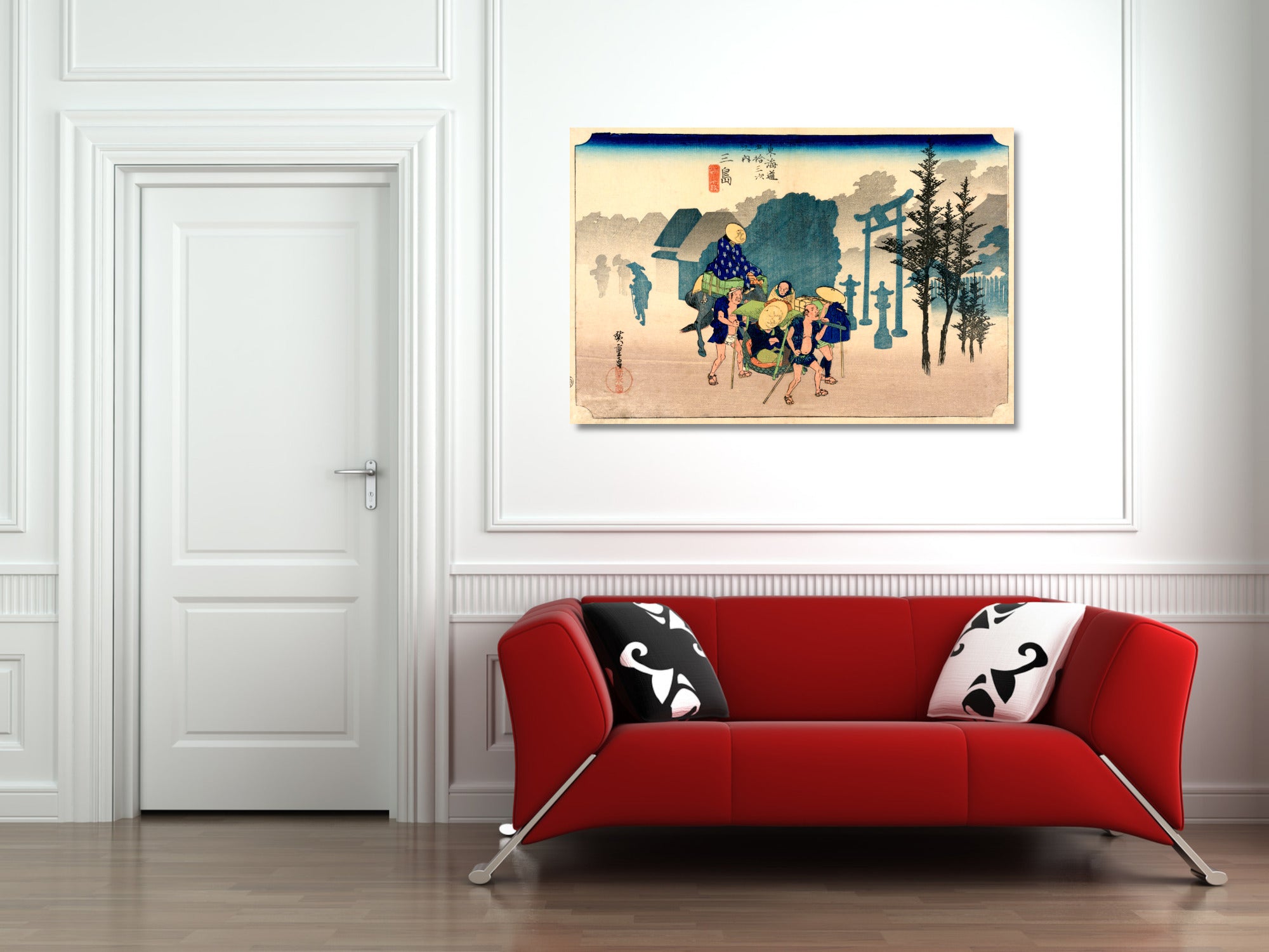 A framed Japanese ukiyo-e woodblock print depicting a samurai warrior scene, displayed on a white wall above a modern red sofa with black and white patterned pillows.