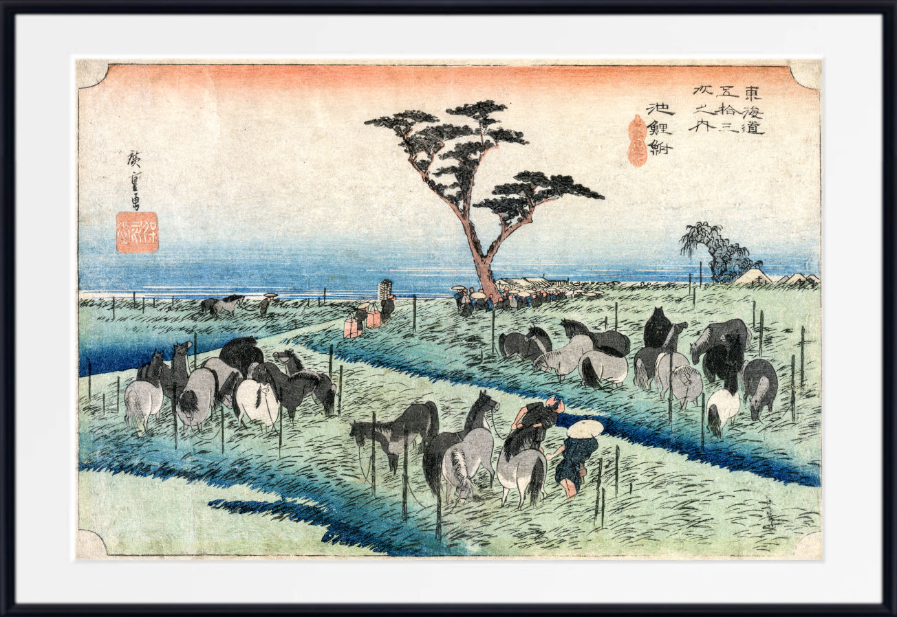 A framed Japanese-style art print depicting a coastal landscape with a flock of horses in a field, a lone tree, and blue water under a pale sky. The print is shown with a white mat and a black frame.