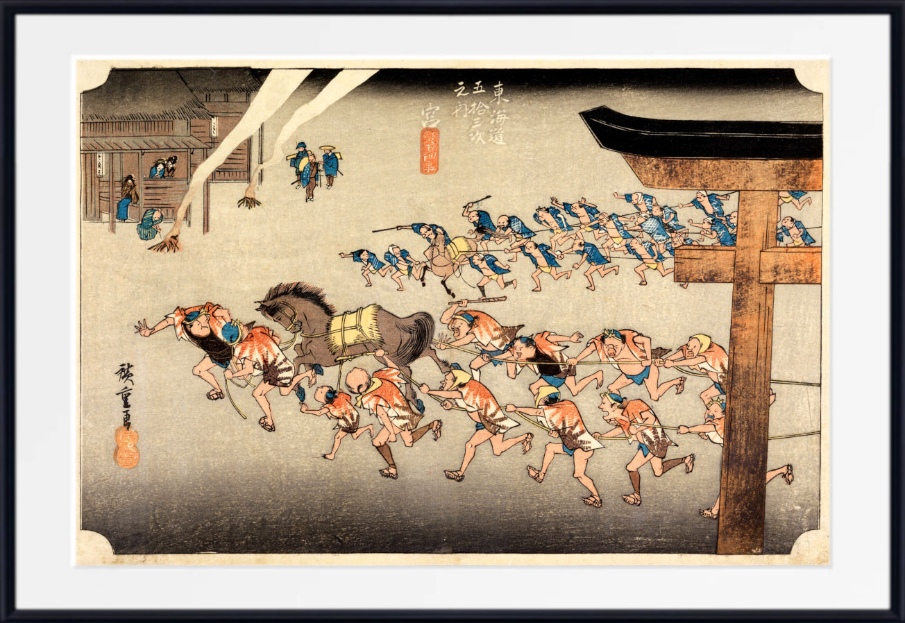 A framed Japanese ukiyo-e woodblock print depicting a dramatic street scene with a horse, running figures, and a large torii gate, shown with a white mat and black frame.