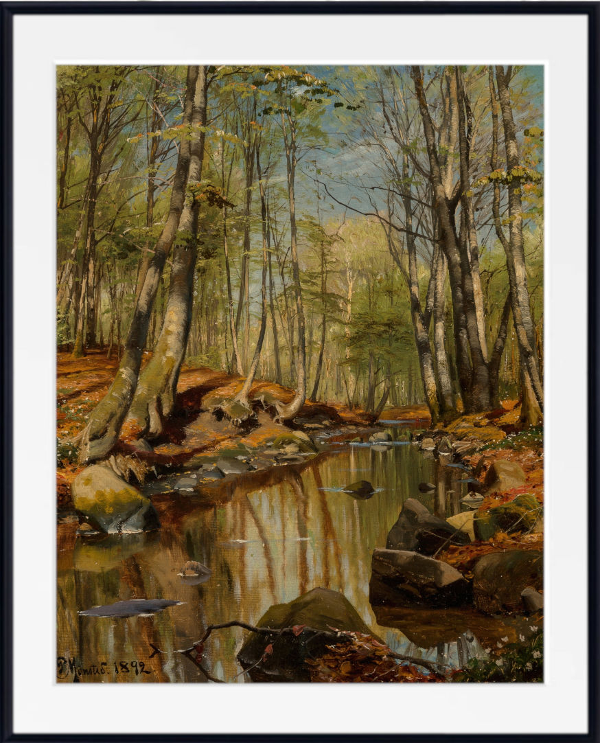 A framed landscape art print depicting a forest stream with trees, rocks, and reflections, shown with a white mat and black frame.