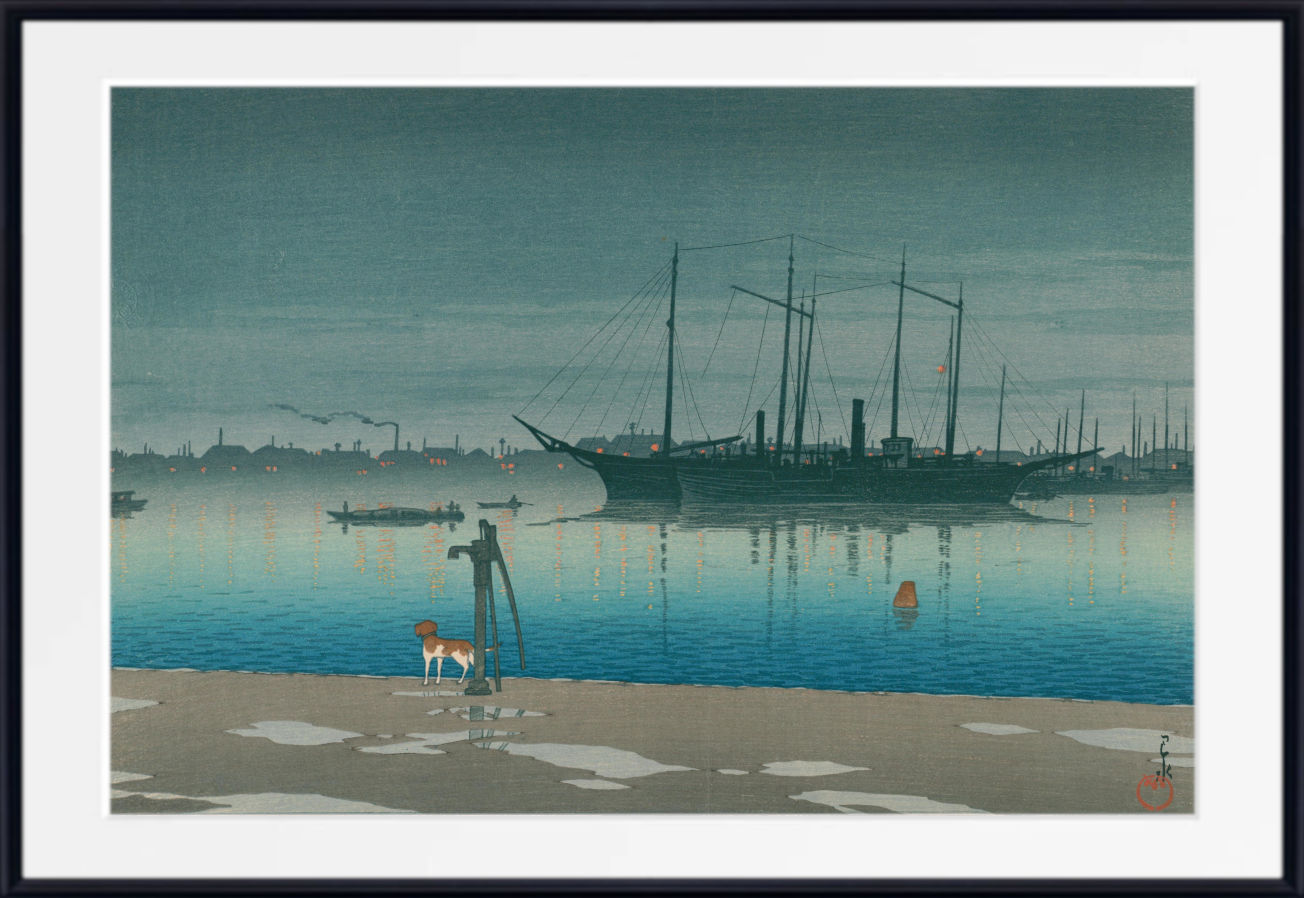 A framed art print depicting a calm harbor scene with a large sailing ship on blue water, a sandy foreground, and a city skyline in the distance under a misty sky.