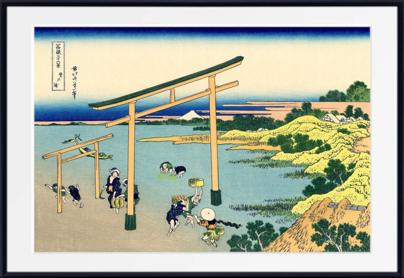 A framed Japanese ukiyo-e woodblock print depicting figures near torii gates by the water, with pale blue water, green trees, and a cream sky, shown in a black frame with a white mat.
