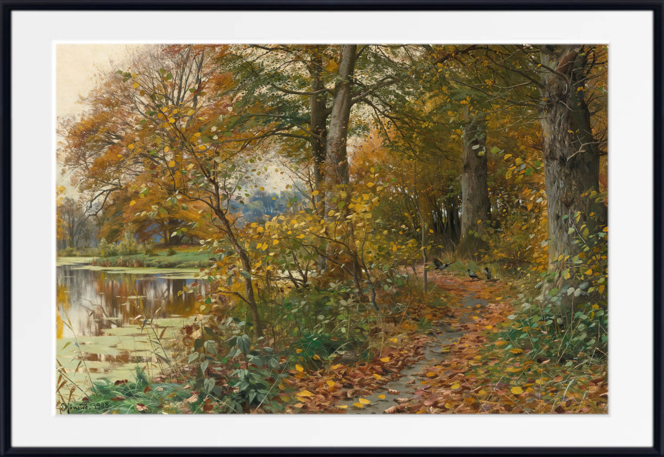 A framed landscape art print depicting an autumn forest scene with a path, trees, and a reflective pond, shown with a white mat and black frame.