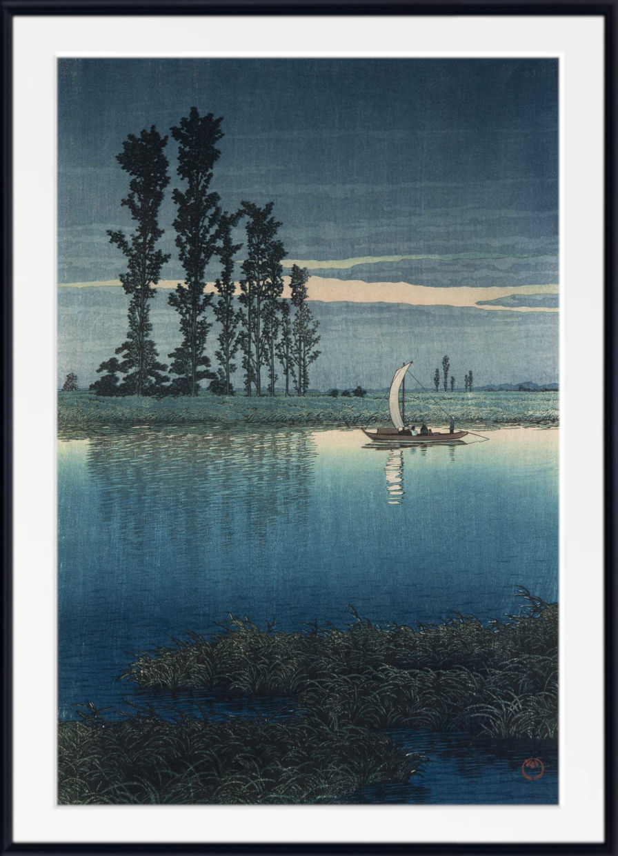 A framed Japanese-style art print depicting a tranquil lake scene at dusk or dawn, with tall dark trees on the left, a small sailboat on the water, and a pale sky. The print is shown with a white mat and a black frame.