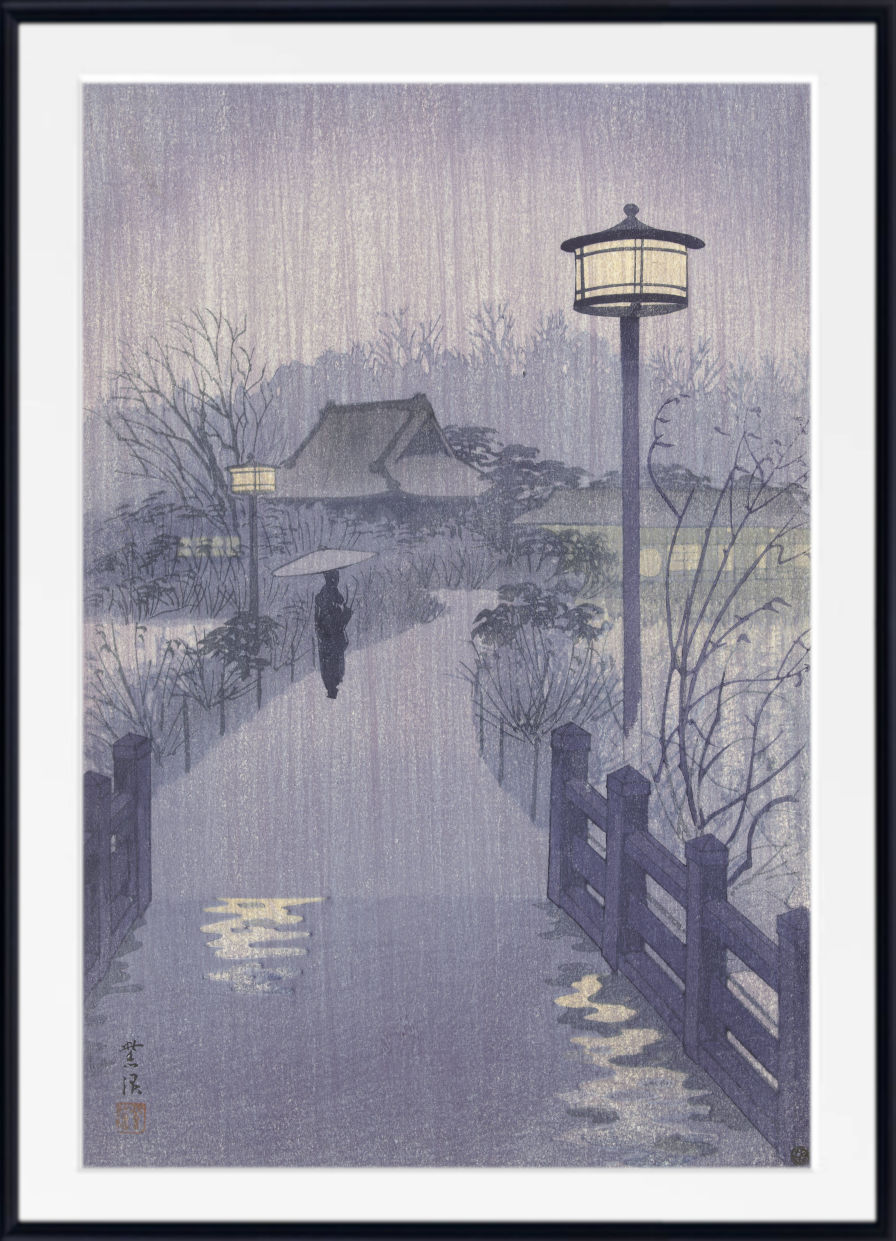 A framed Japanese-style art print depicting a rainy scene with a pathway, lanterns, bare trees, and a small house, shown against a white background with a black frame.