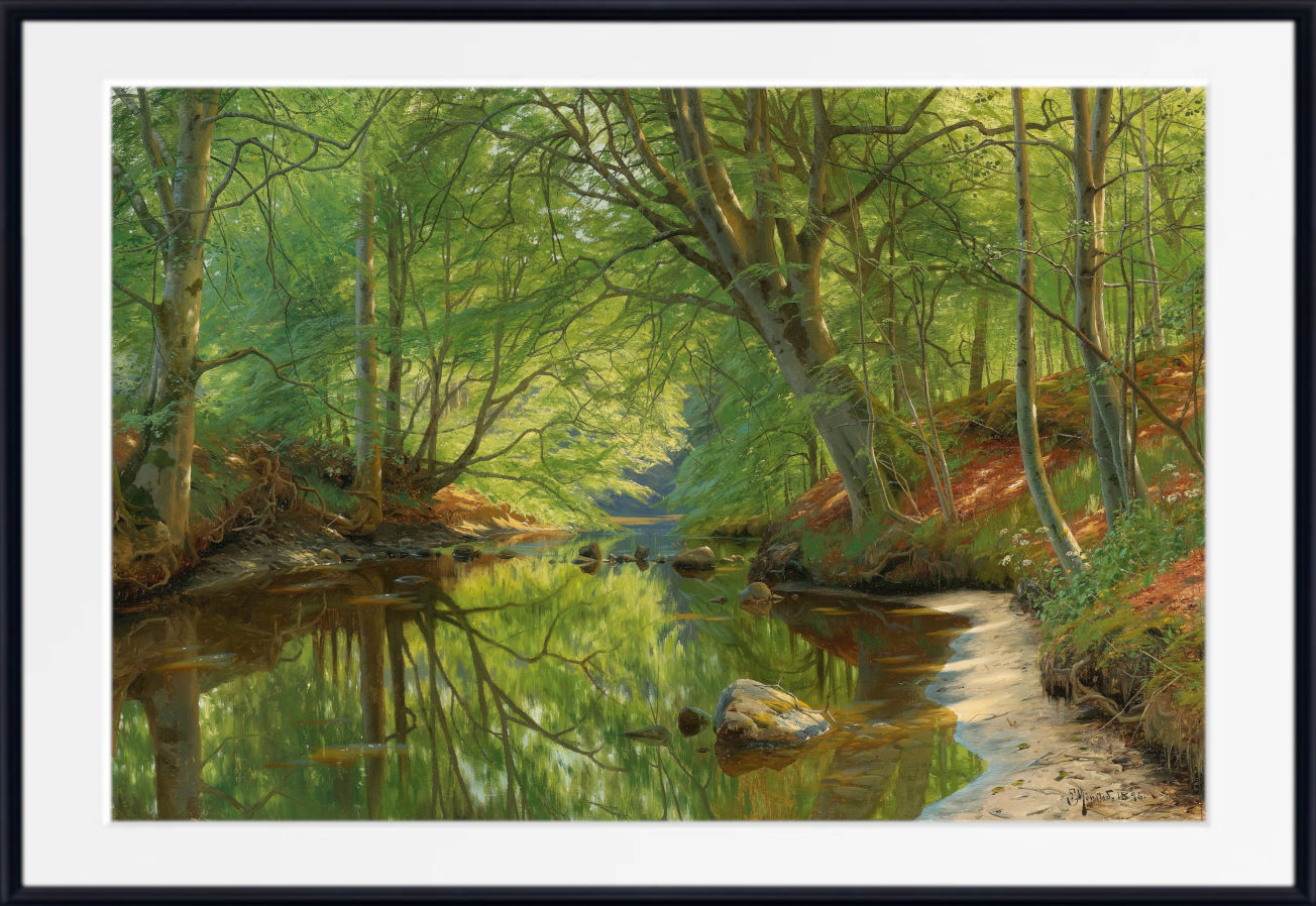 A framed landscape painting of a sunlit forest stream, with green trees, reflections in the water, and a pale path along the right bank, shown with a white mat and black frame.