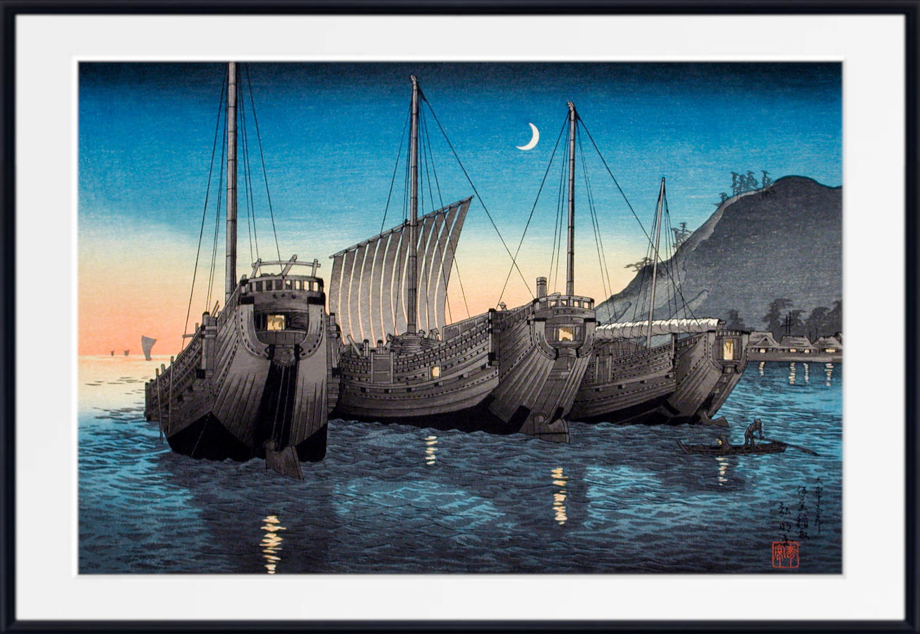 A framed Japanese-style art print depicting three large traditional wooden ships anchored in a harbor at dusk, with a crescent moon in the sky and a dark hillside in the background.