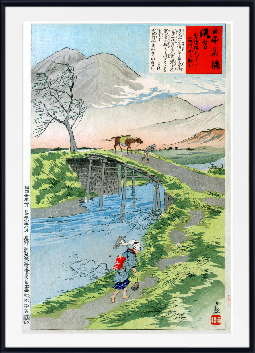 A framed Japanese ukiyo-e woodblock print depicting a mountain landscape with a river, bridge, tree, and figures, shown against a white background with a black frame.