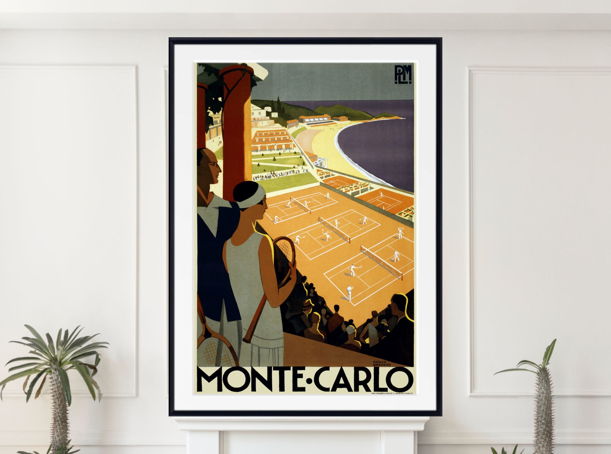 A framed vintage-style travel poster of Monte-Carlo, shown hanging on a white wall above a mantel with small potted plants. The poster features an Art Deco illustration of tennis courts, a beach, and two spectators, with the text 'MONTE-CARLO' at the bottom.
