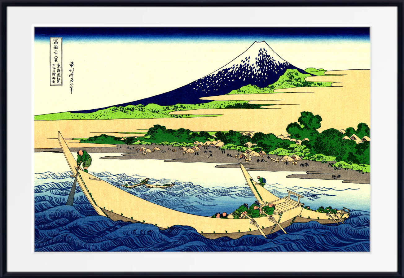 A framed Japanese-style art print depicting a snowy mountain, shoreline, boats, and blue waves, shown against a white mat and black frame.