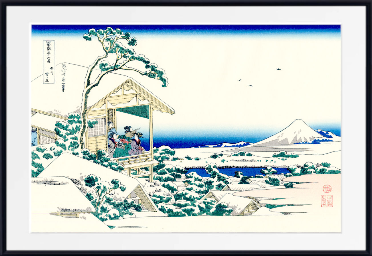 A framed Japanese-style art print depicting a snowy landscape with a small wooden pavilion, snow-covered trees, blue water, and a distant mountain under a deep blue sky.