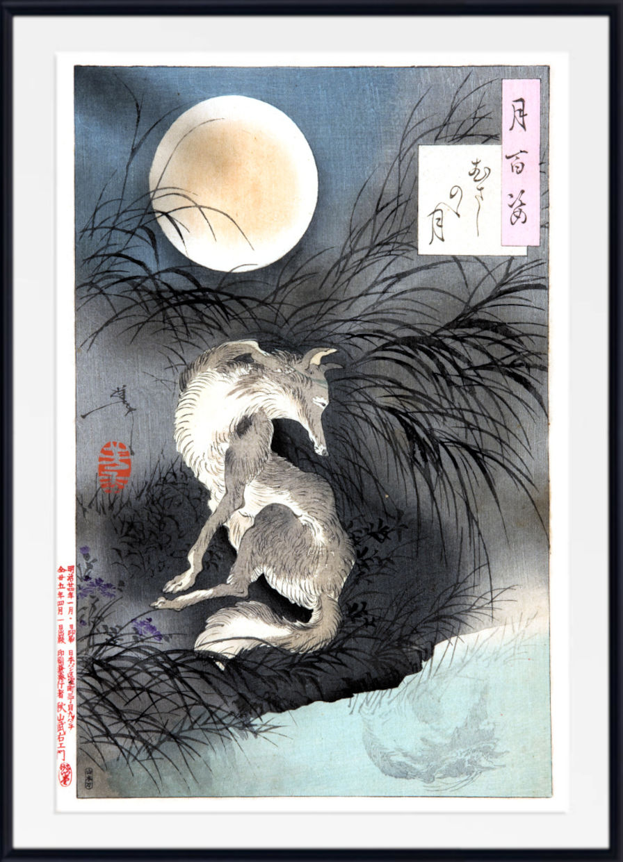 A framed Japanese-style art print depicting a fox at night under a large full moon, with dark grasses, a pale blue-gray sky, and calligraphic text blocks. The print is shown with a white mat and black frame.