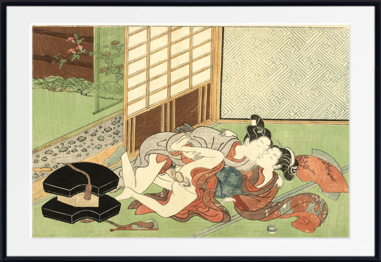 A framed Japanese-style art print depicting two figures reclining in a room with shoji screens, a patterned wall, and a black box in the foreground, shown against a white mat and black frame.