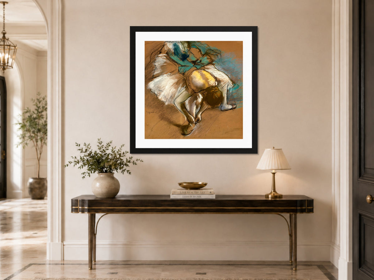 Edgar Degas Print, Danseuse attachant son chausson (1887) displayed above a console table