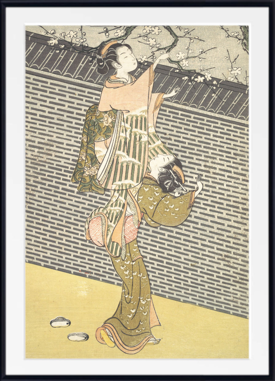 A framed Japanese-style art print depicting a woman in a kimono holding a basket, with cherry blossoms and a brick wall in the background.