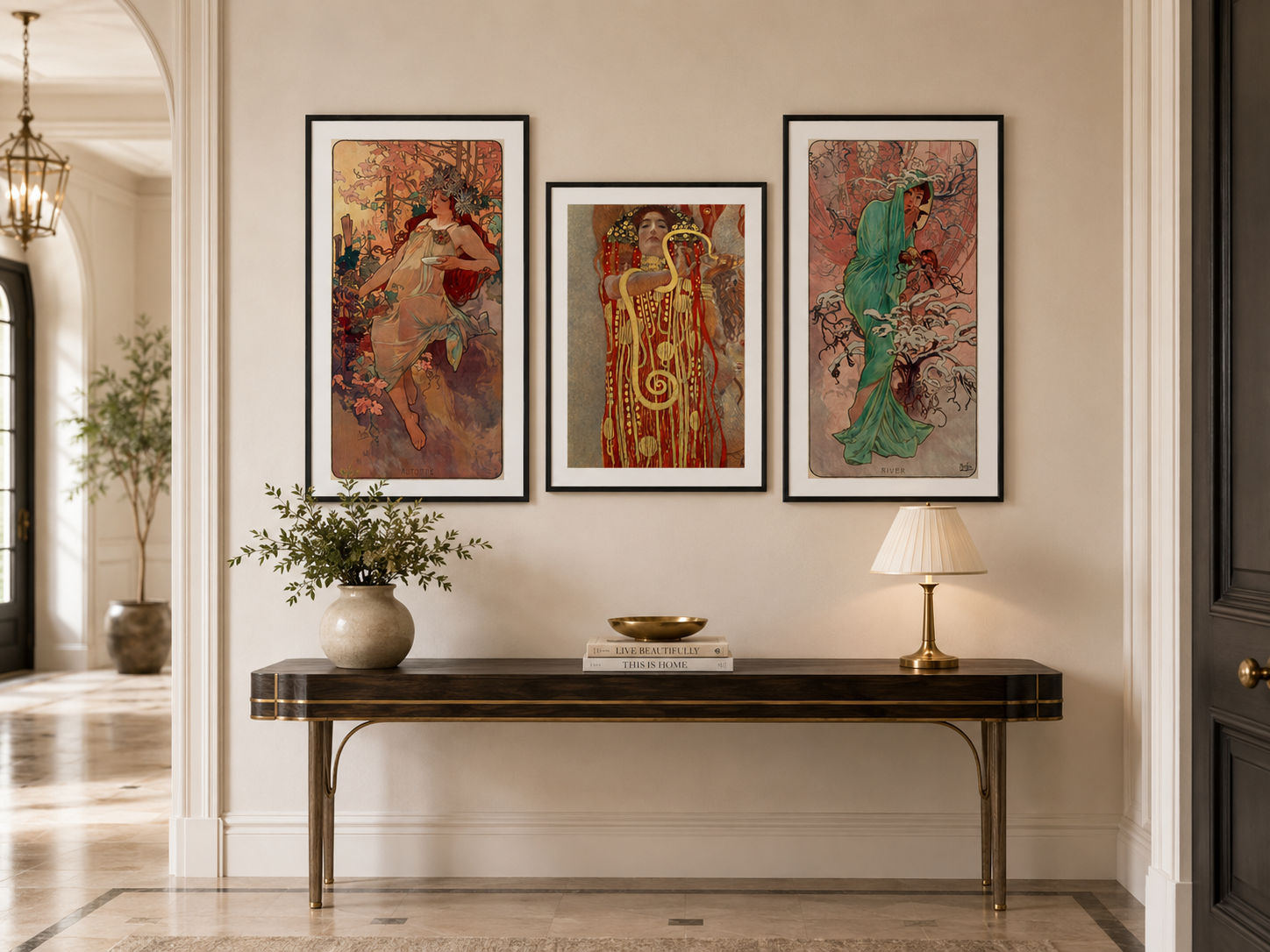 Three framed art prints featuring classical figures in warm and vibrant tones, displayed on a beige wall above a dark console table in a beautifully styled interior hallway.