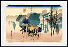 A framed Japanese ukiyo-e woodblock print showing a group of figures carrying a person in a basket outdoors, with torii gates, trees, and a house in the background. The print is mounted with a white mat and a black frame.