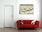 A framed Japanese-style winter landscape print hangs on a white paneled wall above a bright red sofa with black-and-white patterned pillows in a modern living room setting.