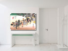 A framed art print depicting a traditional Japanese street scene with figures and horses, displayed on a white wall above a console table in a minimalist white room.