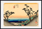 A framed Japanese ukiyo-e woodblock print depicting a coastal landscape with pine trees, a blue sea, and a pale peach sky, shown with a white mat and black frame.