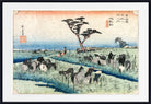 A framed Japanese-style art print depicting a coastal landscape with a flock of horses in a field, a lone tree, and blue water under a pale sky. The print is shown with a white mat and a black frame.