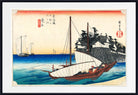 A framed Japanese-style art print showing a wooden sailing boat on blue ocean waves near a rocky shoreline with buildings, under a pale sky with red-orange bands and Japanese text seals.