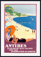 A vintage-style illustrated beach poster for Antibes, showing a sandy shore, blue sea, boats, and two women in the foreground. The poster has a white mat and a black frame, with French text at the bottom reading 'ANTIBES' and additional coastal promotional text.