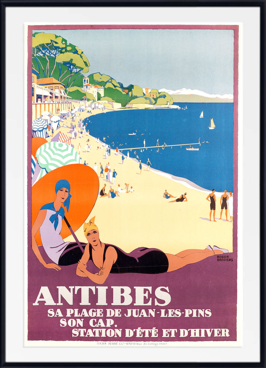 A vintage-style illustrated beach poster for Antibes, showing a sandy shore, blue sea, boats, and two women in the foreground. The poster has a white mat and a black frame, with French text at the bottom reading 'ANTIBES' and additional coastal promotional text.