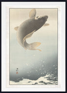 A framed Japanese-style art print depicting a large koi fish leaping through water, with a white mat and black frame around the artwork.