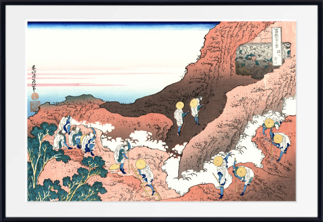 A framed Japanese-style art print depicting a coastal mountain scene with figures walking along a path, shown against a white mat and black frame.