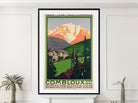 A framed vintage-style travel poster of Combloux, Switzerland, hanging on a white wall above a mantel, flanked by small potted plants. The poster features a retro illustration of a mountain, green valley, and buildings, with the text 'PARIS - LYON - MEDITERRANEE' at the top and 'COMBLOUX 1966' at the bottom.