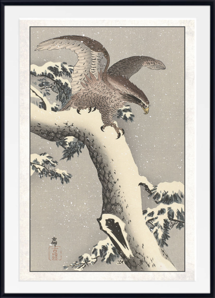 A framed Japanese-style art print depicting a large bird of prey perched on a snow-covered tree branch in a winter scene, with a white mat and black frame.