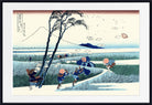 A framed Japanese-style art print depicting a landscape with figures in a field, a tree, distant mountains, and floating paper, shown against a white mat and black frame.
