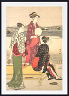 A framed Japanese ukiyo-e woodblock print depicting three women in traditional kimonos near a waterfront, with a light beige background and a black frame with white matting.