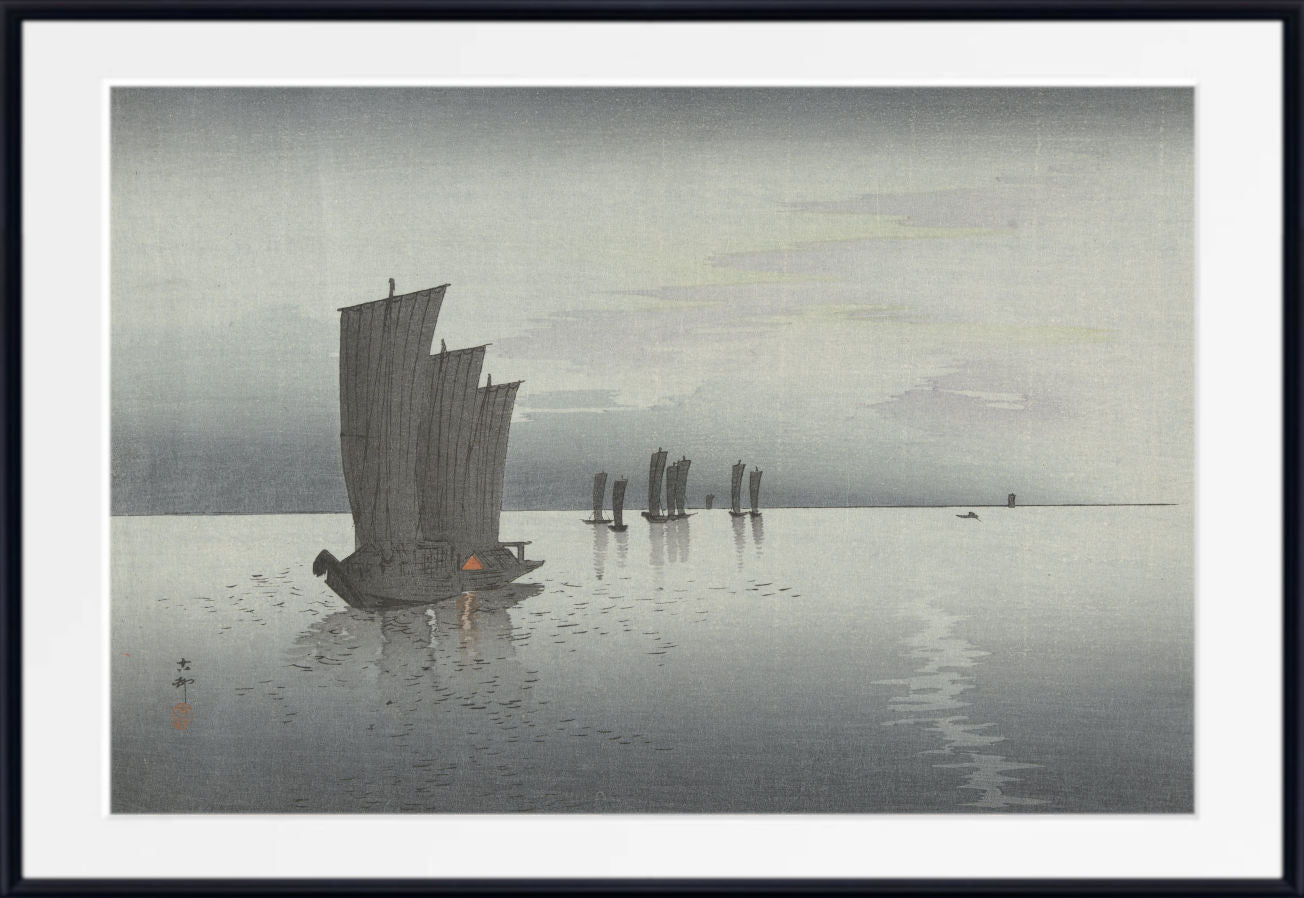 A framed art print depicting a Japanese-style seascape with a large sailboat on calm water under a pale sky, shown with a white mat and black frame.