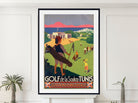 A framed vintage-style travel poster for 'GOLF de la Soukra TUNIS' hangs on a white wall above a mantel, flanked by small potted plants. The poster features retro illustration art of people playing golf on a green hillside with mountains and a pink sky in the background.