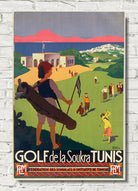 A vintage-style illustrated poster for Golf de la Soukra Tunis, showing a golfer carrying a bag on a golf course with hills, buildings, and mountains in the background. The poster is displayed against a white brick wall.