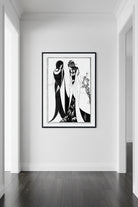 A black and white Art Deco style illustration print featuring two elegant women in long, flowing dresses, framed by a white mat and a black frame.