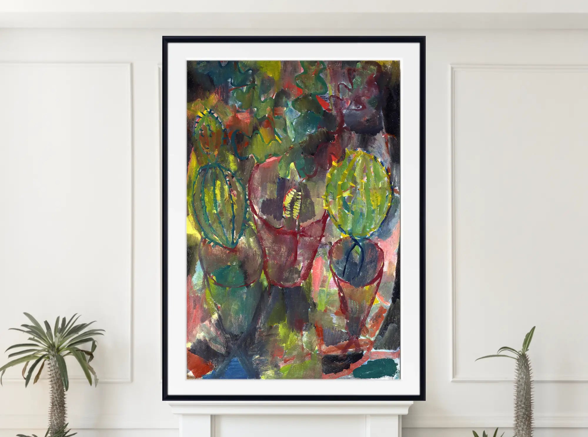 A framed abstract art print featuring a colorful still life of green and red glasses, displayed on a white wall above a white mantelpiece with small potted plants on either side.  Paul Klee Fine Art Print, Kakteen (1912)