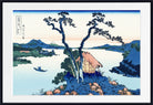 A framed Japanese-style landscape print showing a small thatched-roof cottage beside a calm lake, with mountains in the background, blue trees, and a boat on the water. The artwork is presented with a white mat and black frame.
