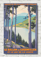A vintage-style travel poster print featuring a scenic lake and forest landscape with tall trees framing the view. The poster includes orange text reading 'CHEMINS DE FER D'ALSACE ET DE LORRAINE' at the top and 'LE BALLON DE GUEBWILLER ET LE LAC DE LA LAUCH' at the bottom.