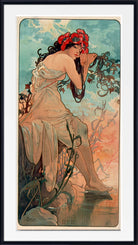 A framed vintage Art Nouveau style print featuring a seated woman in flowing pale drapery, with a red flower crown, against a sky-like background in blue, peach, and orange tones.