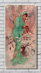 An Art Nouveau style poster print featuring a woman in a flowing green dress standing among snow-covered branches, with the title 'RIVER' at the bottom, displayed against a white brick wall.