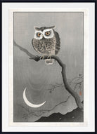 A framed Japanese-style art print featuring a detailed owl perched on a branch under a crescent moon, with a white mat and black frame.