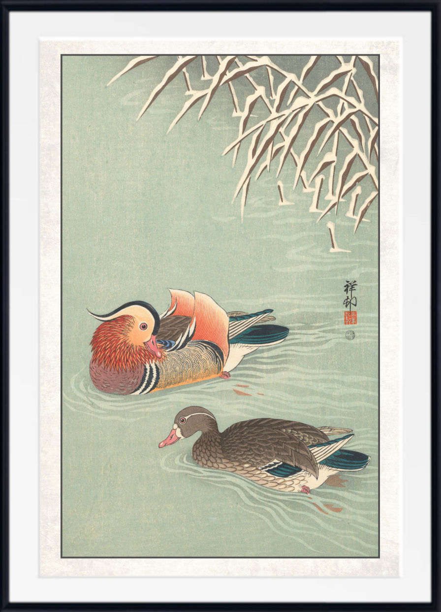 A framed Japanese-style art print depicting two ducks swimming in pale green water with reeds at the top and a white mat border.