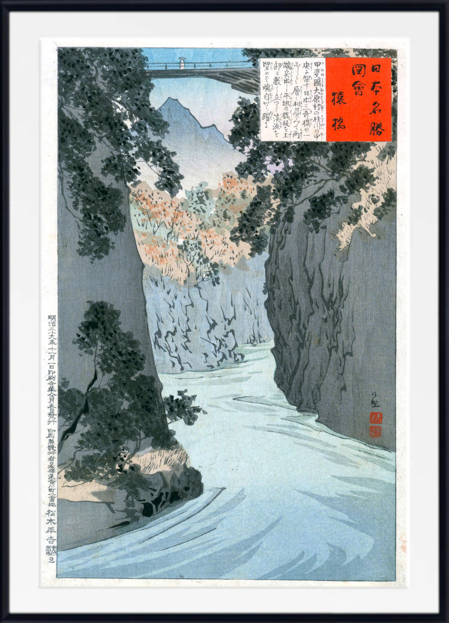A framed Japanese woodblock-style landscape print showing a river flowing through a rocky canyon with trees and mountains in the background. The artwork includes a white border, black frame, and red text boxes with calligraphy.