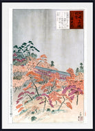 A framed Japanese-style art print depicting an autumn landscape with orange and purple foliage, a long bridge, and a pale sky, shown with a white mat and black frame.