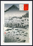 A framed Japanese ukiyo-e woodblock print depicting a snowy mountain landscape with trees, rocks, and handwritten text boxes in the upper right, shown against a white background.