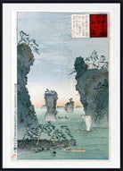 A framed Japanese ukiyo-e woodblock print depicting a coastal landscape with tall rocky cliffs, sea stacks, a small sailboat, and a canoe on calm water. The print has a white mat and a black frame, with a red and white seal block printed in the upper right corner.