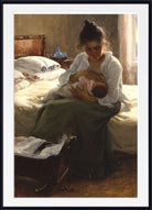A framed classical painting depicting a mother in a white blouse and dark green skirt nursing her baby on a bed, with a black frame and white mat border.